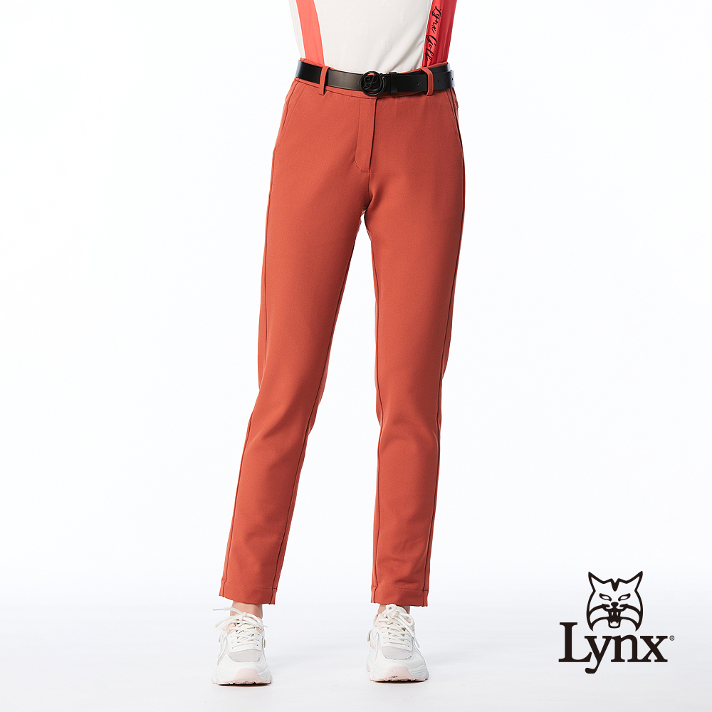 【Lynx Golf】女款日本進口布料彈性舒適素面脇邊剪裁造型窄管長褲-橘色